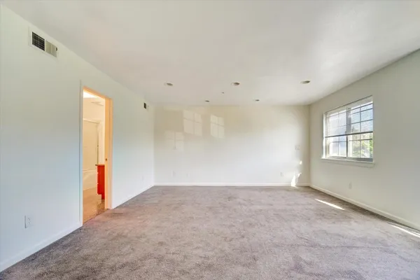 an empty room with windows and closet