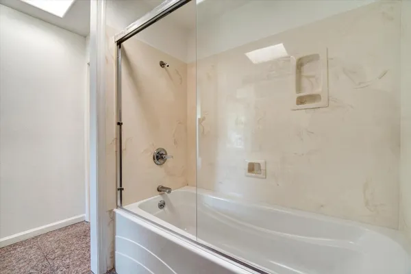 a bathroom with a bathtub and a shower