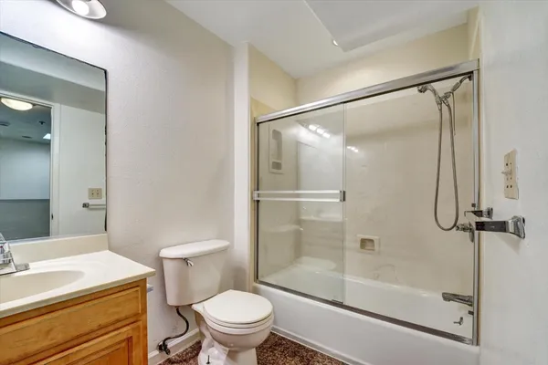 a bathroom with a sink mirror vanity and toilet