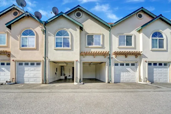 a front view of a house with a road