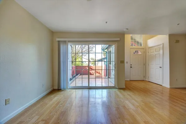 wooden floor in an empty room with a window