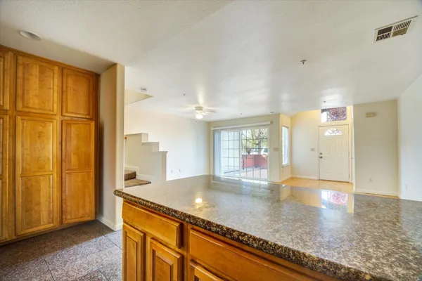 a view of a kitchen with granite countertop a sink and dishwasher