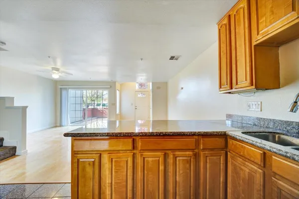 a kitchen with granite countertop a sink and a window