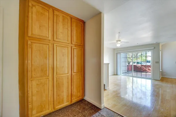 a view of a hallway with wooden floor