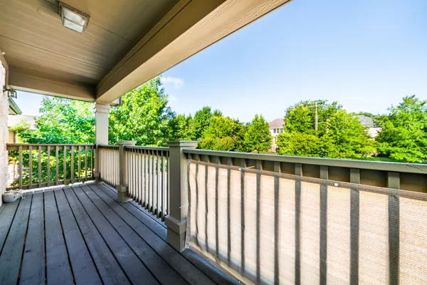 a balcony with wooden floor and outdoor space
