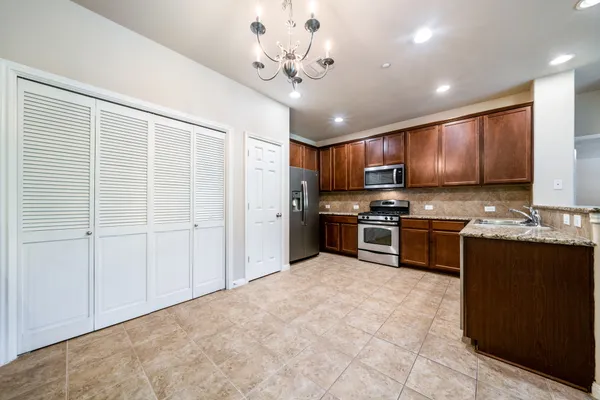 a large kitchen with granite countertop a large counter top and sink