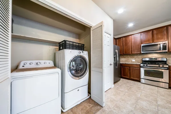 a view of a refrigerator in kitchen and hallway