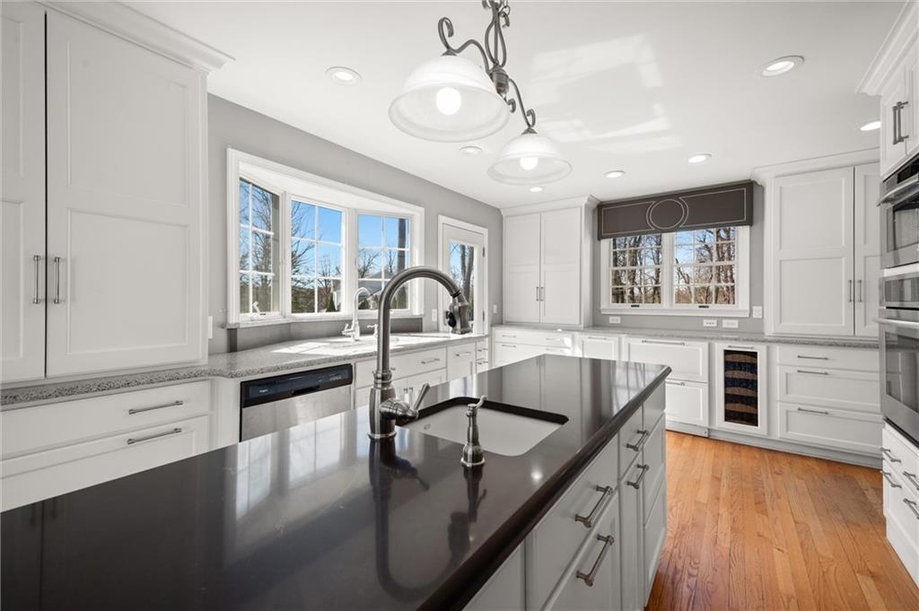 2996 Mercer West Middlesex Road West Middlesex, PA 16159 - Photo 22 of 48 a kitchen with stainless steel appliances granite countertop a sink a stove and a wooden floors