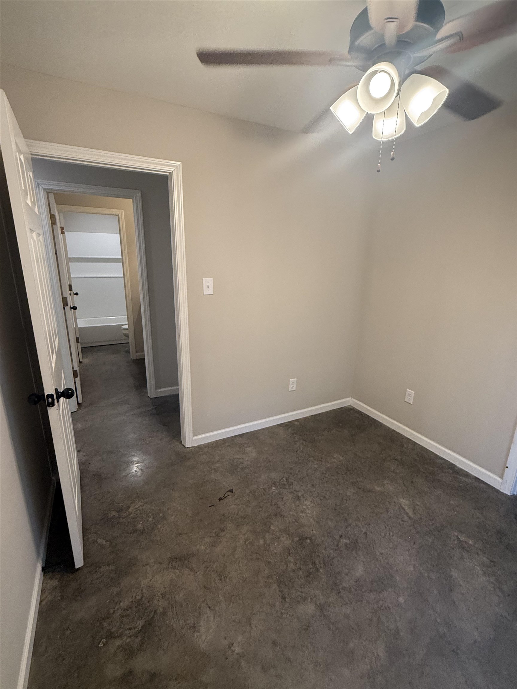 4589 Range Line Road Memphis, TN 38127 - Photo 19 of 25 Empty room with concrete flooring and a ceiling fan