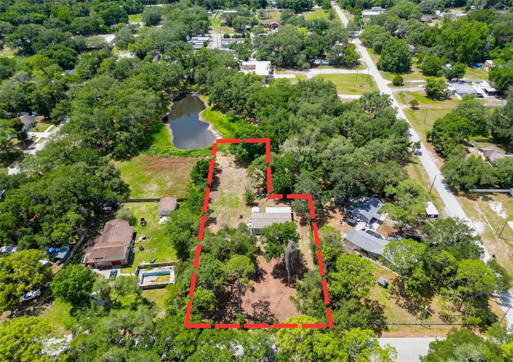 1819 Sinclair Hills Road Lutz, FL 33549 - Photo 2 of 60 an aerial view of residential houses with outdoor space and trees