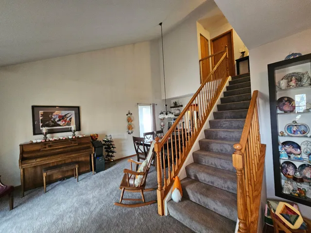 a view of a livingroom with furniture and stairs