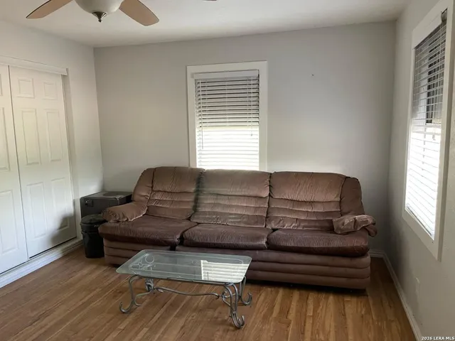 a living room with furniture and wooden floor