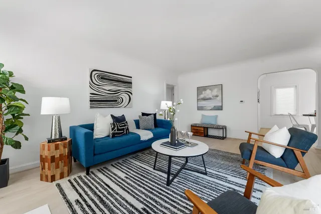 a living room with furniture and wooden floor