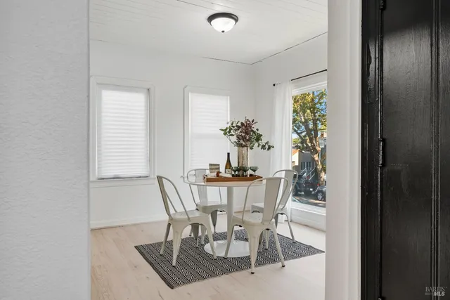 a view of a dining room with furniture and window