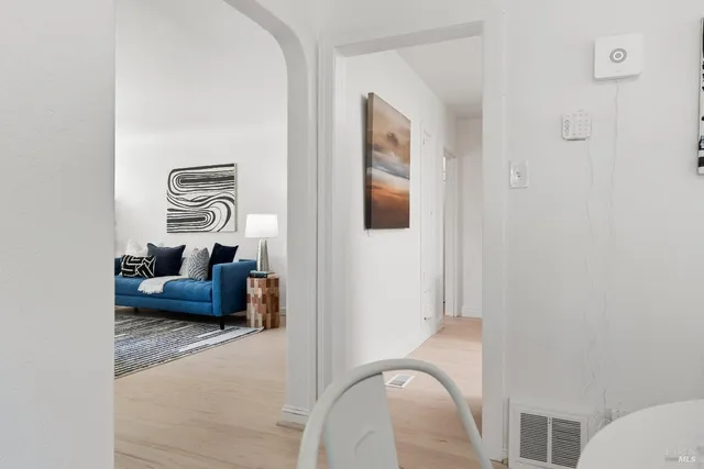 a living room with furniture and a painting