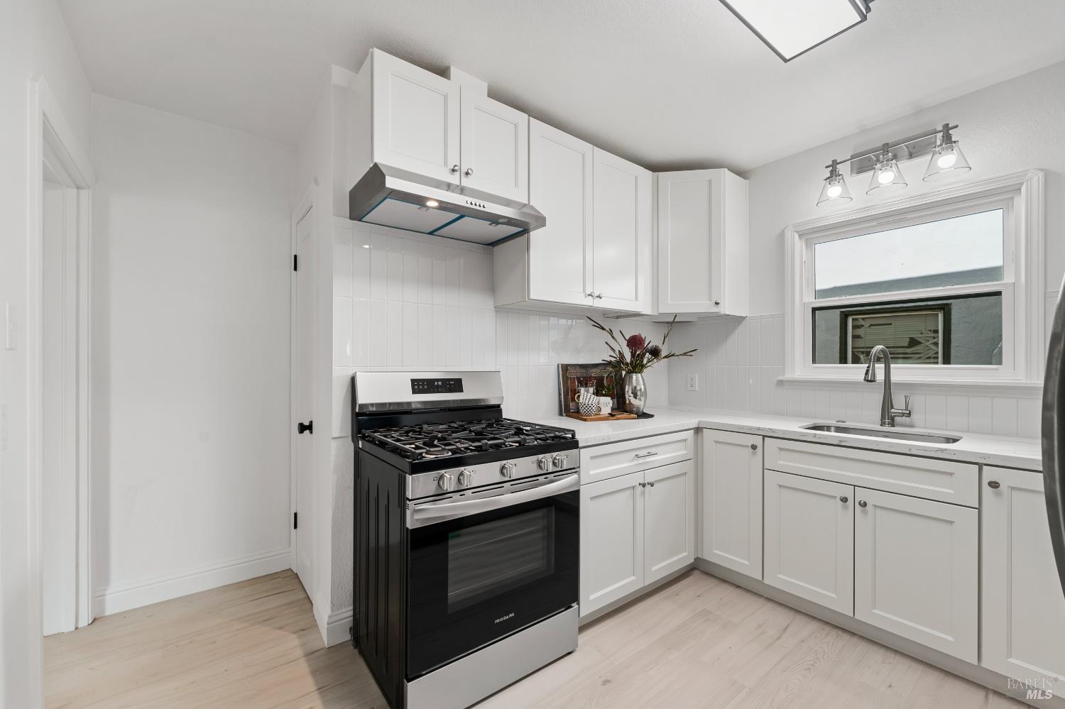 1402 Rice Street Vallejo, CA 94590 - Photo 22 of 55 a kitchen with cabinets stainless steel appliances and a sink