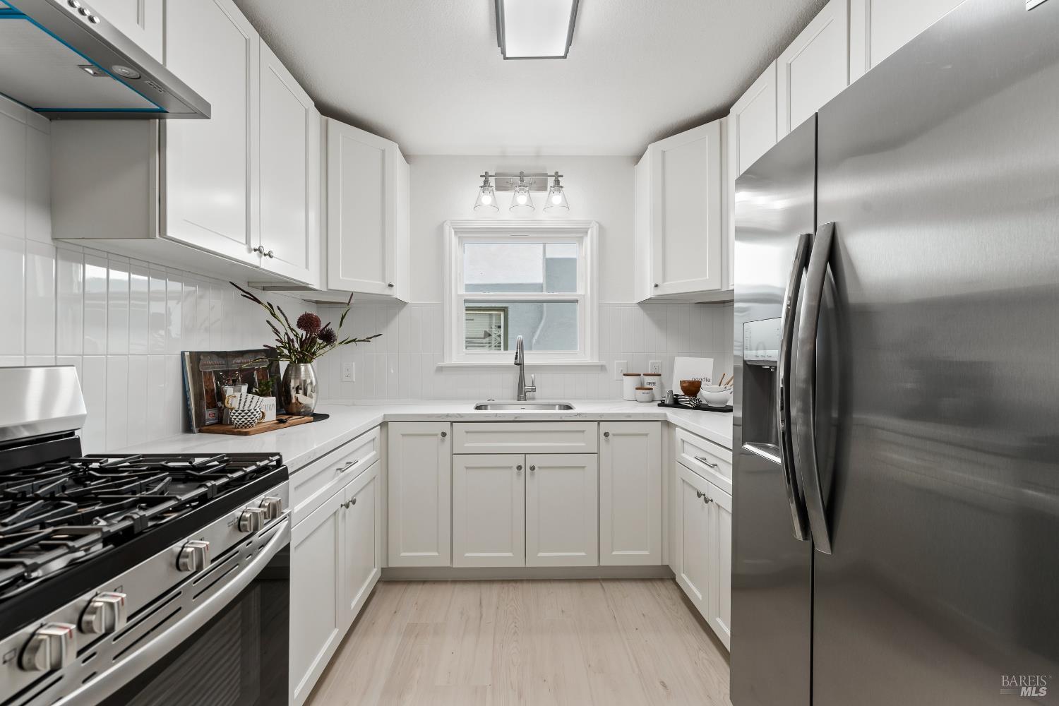 1402 Rice Street Vallejo, CA 94590 - Photo 24 of 55 a kitchen with a sink stove and refrigerator