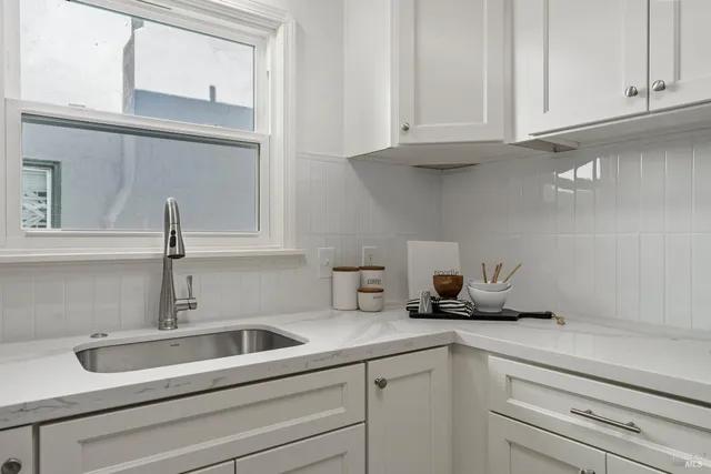 a kitchen with a sink and cabinets