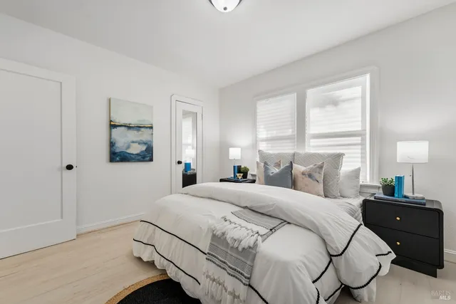 a bedroom with a bed and a night stand