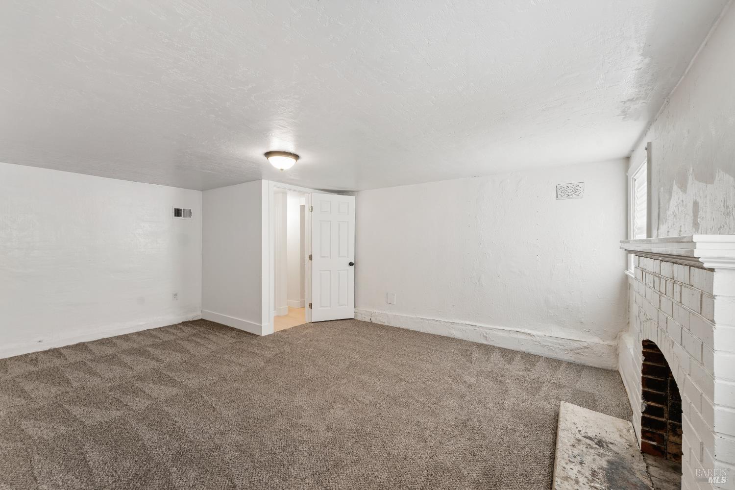 1402 Rice Street Vallejo, CA 94590 - Photo 35 of 55 an empty room with a fireplace