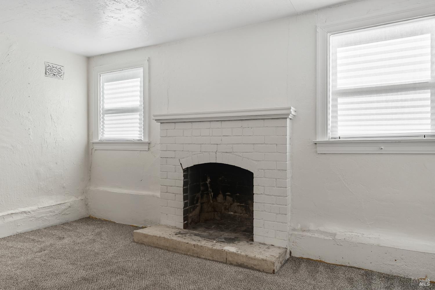 1402 Rice Street Vallejo, CA 94590 - Photo 40 of 55 a living room with a fireplace and windows