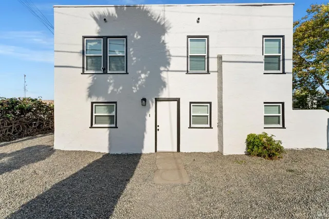 a living room with furniture a fireplace and a table