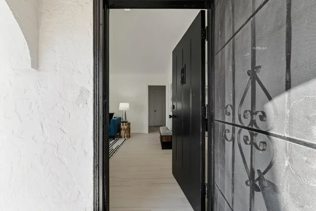 a view of a hallway with a white walls and stairs