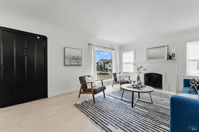 a living room with furniture a rug and a fireplace