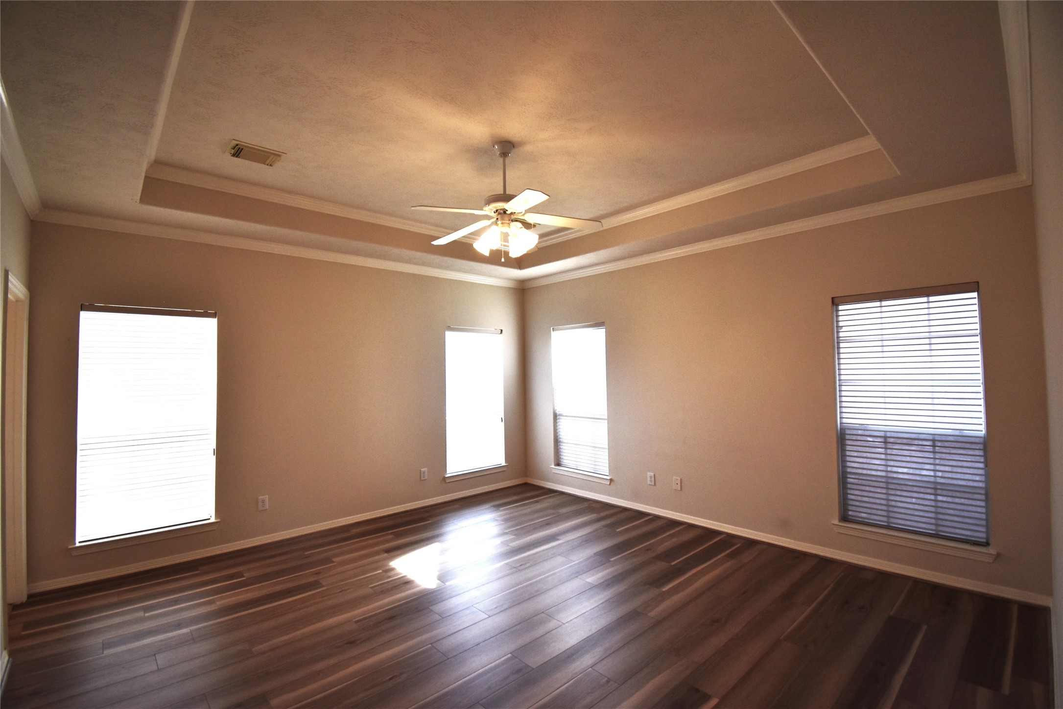 2835 Briarhurst Park Houston, TX 77057 - Photo 14 of 28 an empty room with wooden floor chandelier fan and windows
