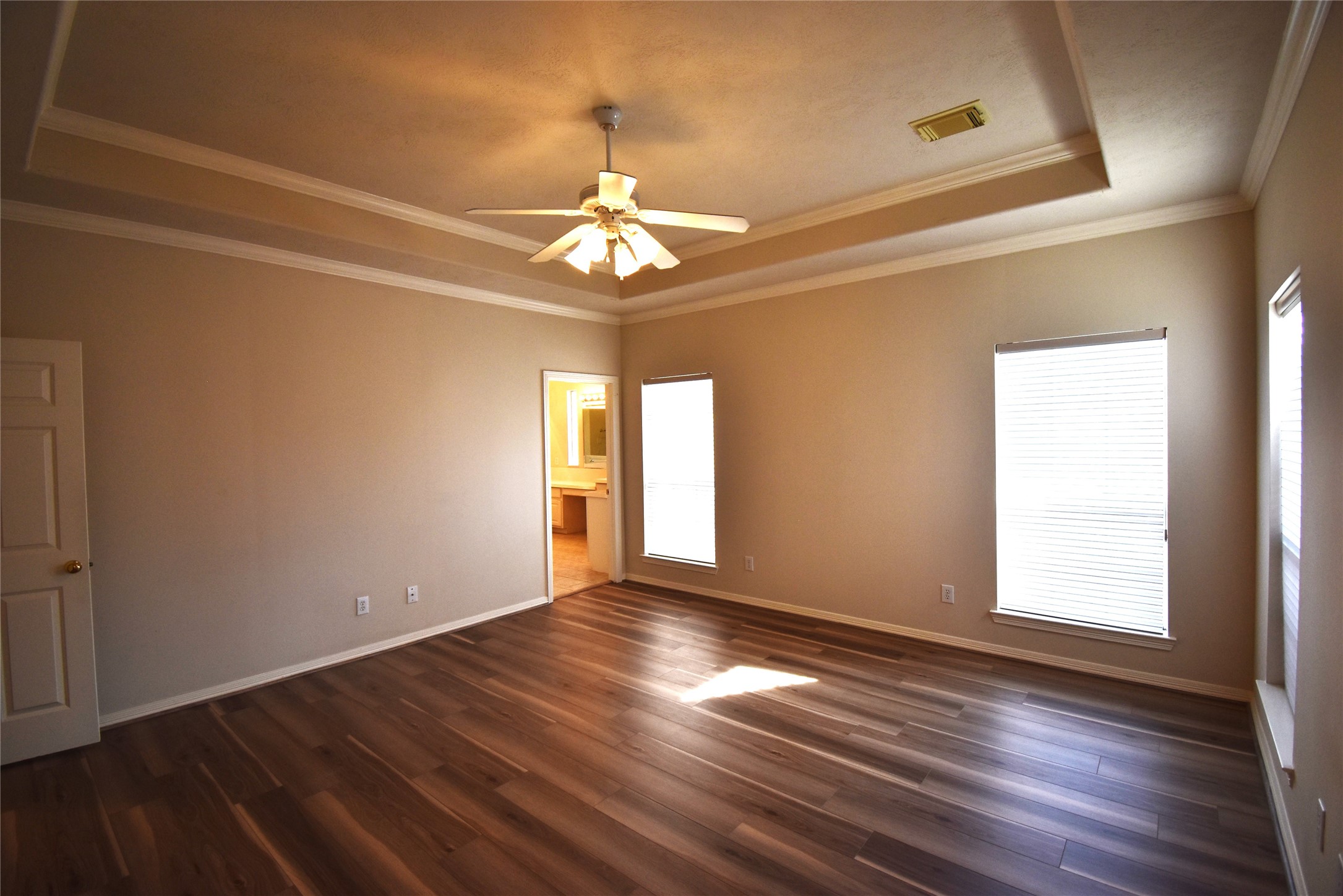 2835 Briarhurst Park Houston, TX 77057 - Photo 15 of 28 an empty room with wooden floor chandelier and windows