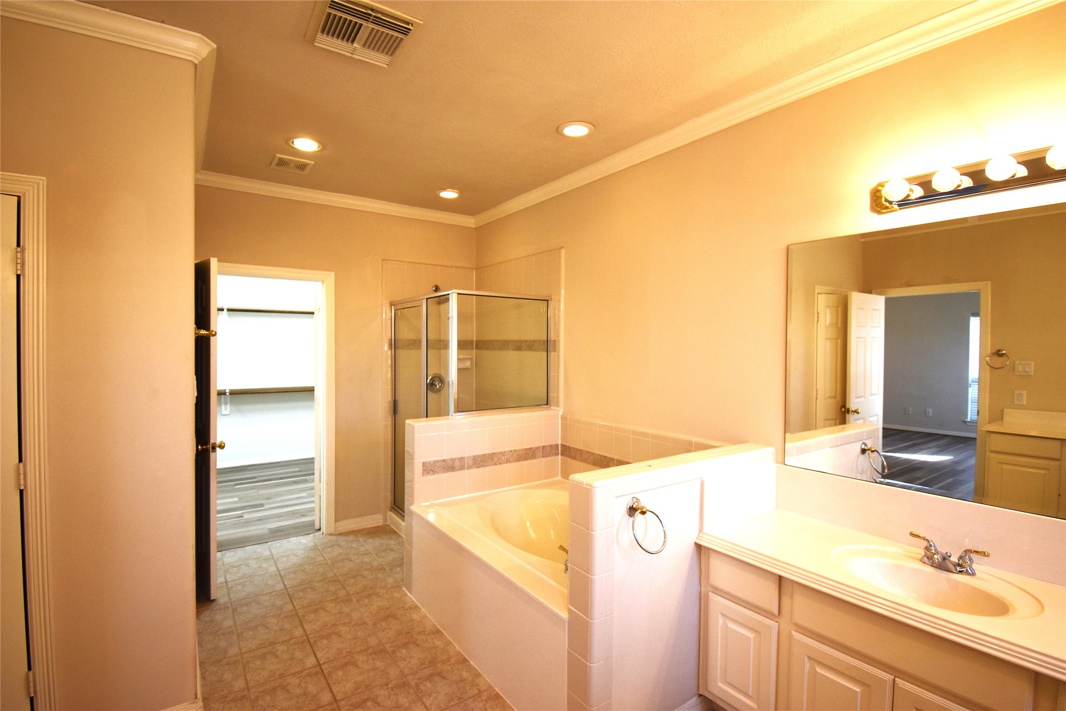 2835 Briarhurst Park Houston, TX 77057 - Photo 17 of 28 a spacious bathroom with a granite countertop sink and a mirror