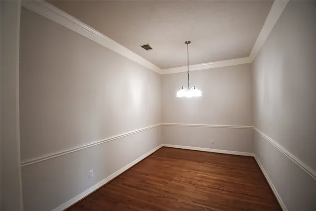 a view of a room with wooden floor and windows