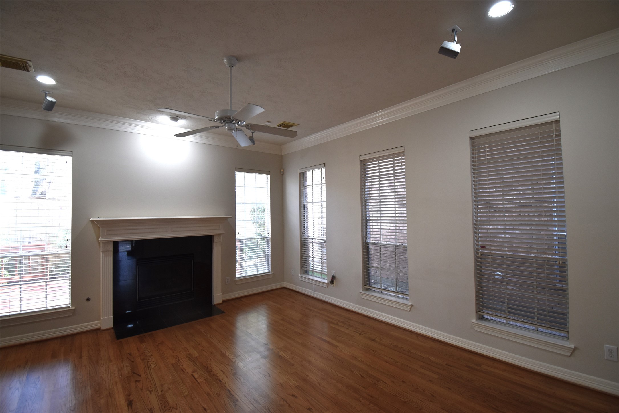 2835 Briarhurst Park Houston, TX 77057 - Photo 6 of 28 a view of an empty room with wooden floor fireplace and a window