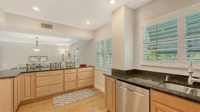 a kitchen with sink cabinets and window