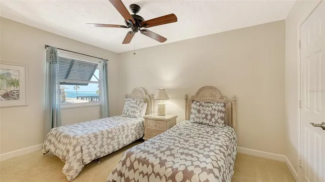 a bedroom with two beds and a window