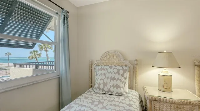 a bedroom with a bed and a mirror