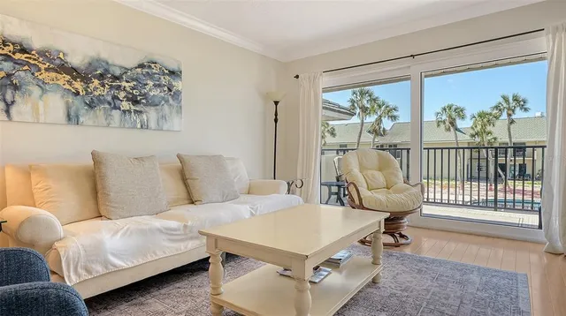 a living room with furniture a rug and a large window