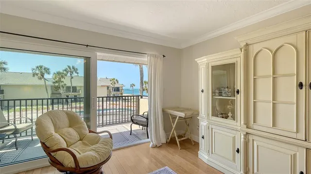 a living room with furniture fireplace and a large window