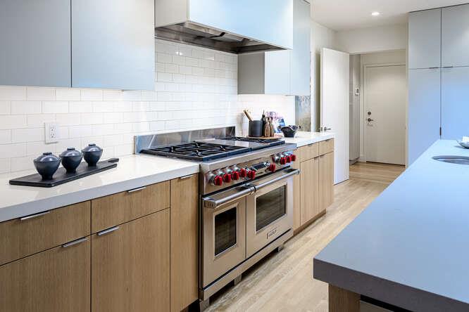 747 Bromfield Road Hillsborough, CA 94010 - Photo 20 of 76 a kitchen with stainless steel appliances a stove a chimney a refrigerator and cabinets