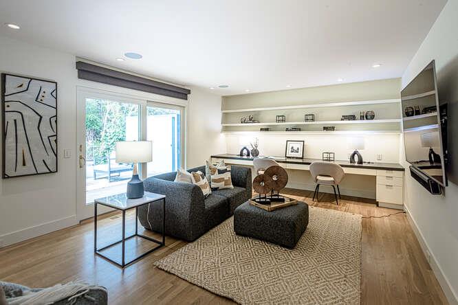 747 Bromfield Road Hillsborough, CA 94010 - Photo 24 of 76 a living room with furniture a flat screen tv and a floor to ceiling window