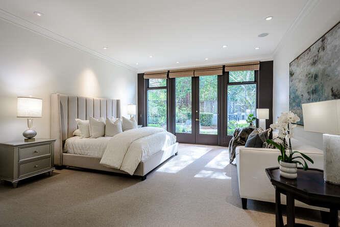 747 Bromfield Road Hillsborough, CA 94010 - Photo 28 of 76 a spacious bedroom with a bed and a large window