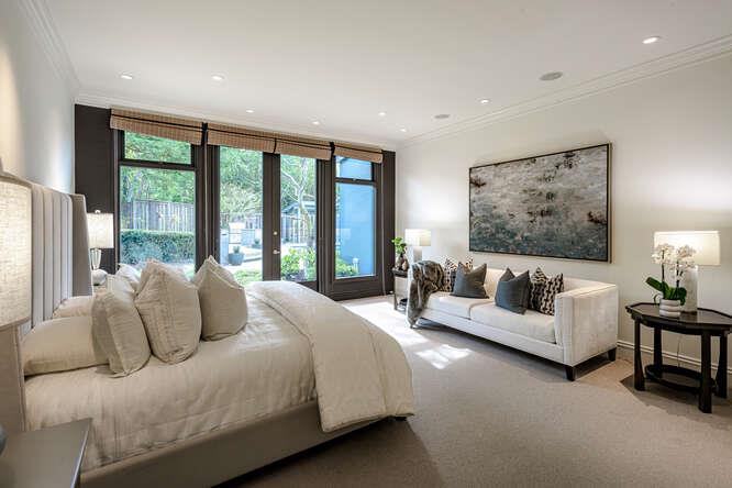 747 Bromfield Road Hillsborough, CA 94010 - Photo 29 of 76 a bedroom with a large bed and a couch