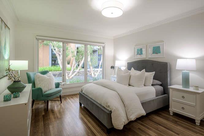 747 Bromfield Road Hillsborough, CA 94010 - Photo 39 of 76 a bedroom with a bed and wooden floor