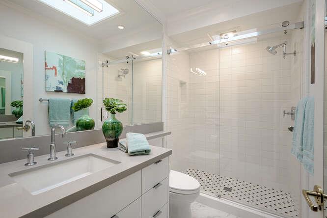 747 Bromfield Road Hillsborough, CA 94010 - Photo 41 of 76 a bathroom with a shower sink vanity mirror and toilet