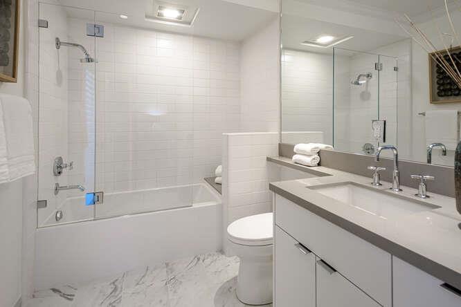 747 Bromfield Road Hillsborough, CA 94010 - Photo 45 of 76 a bathroom with a granite countertop sink a toilet and shower