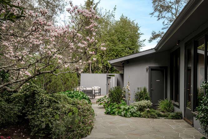 747 Bromfield Road Hillsborough, CA 94010 - Photo 51 of 76 a view of a house with a yard and potted plants