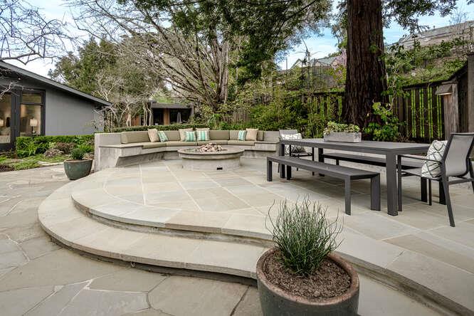 747 Bromfield Road Hillsborough, CA 94010 - Photo 55 of 76 a view of a patio with a table chairs and a fire pit