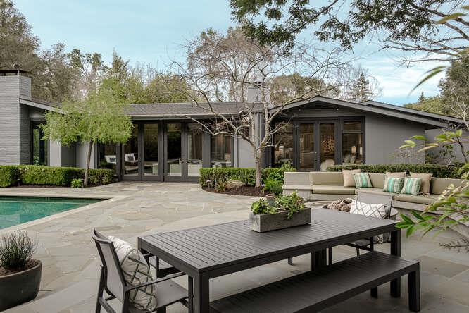 747 Bromfield Road Hillsborough, CA 94010 - Photo 58 of 76 a view of a patio with table and chairs and potted plants