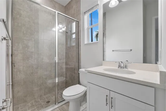 a bathroom with a sink toilet and shower