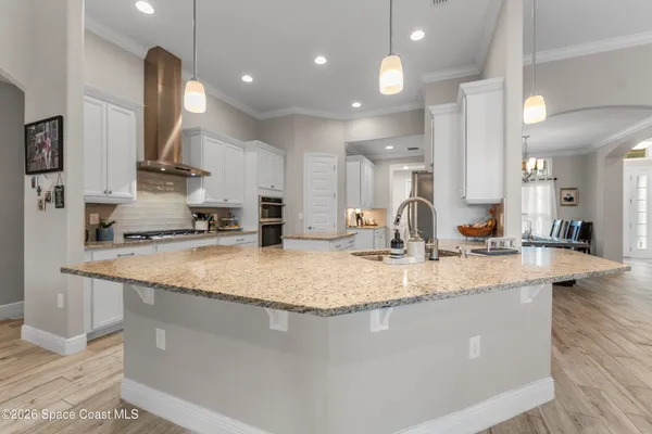 a large kitchen with kitchen island a sink stainless steel appliances and a counter top